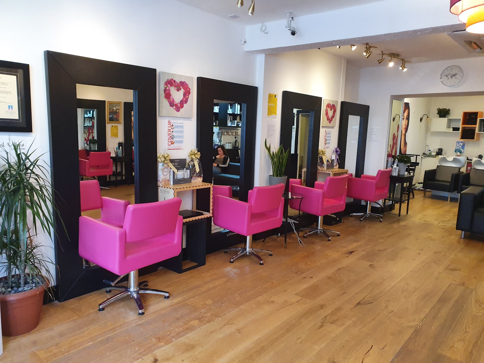 Pink styling chairs, black-framed mirrors and a wash area inside Sunny's Hair & Beauty